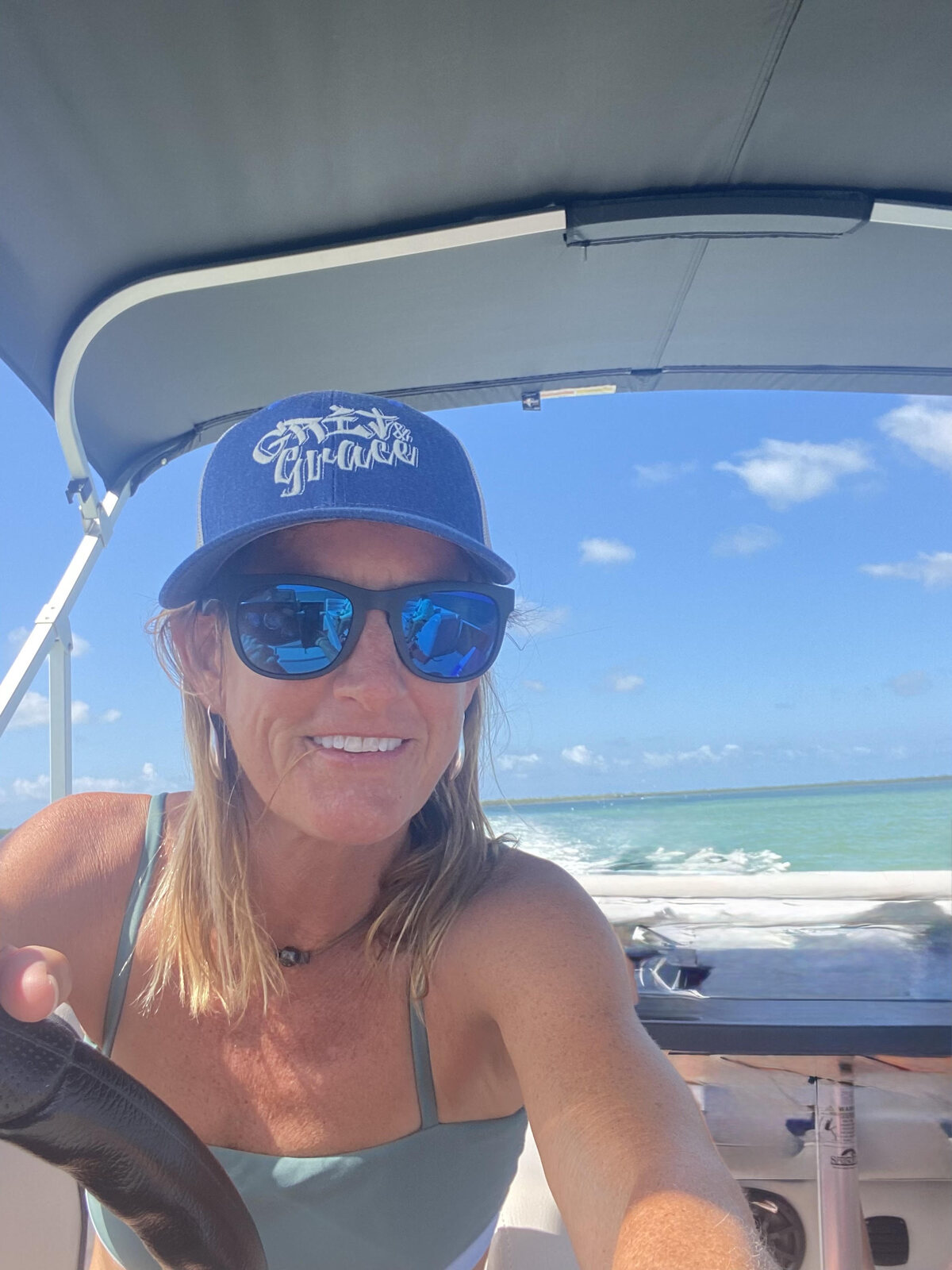 Annie at the helm of a boat in the Florida Keys